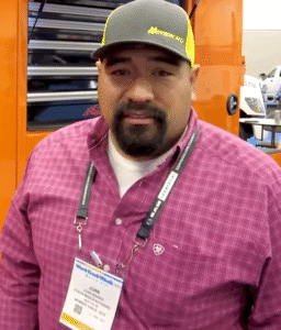 Juan Ibarra at a work truck event in 2025 wearing a pink shirt and cap – Gold Rush mechanic and business owner from Nevada