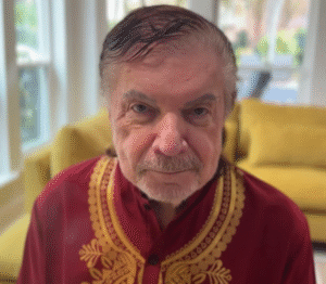 Mike Murdock wearing a red embroidered shirt, recent 2025 photo for biography and net worth profile.
