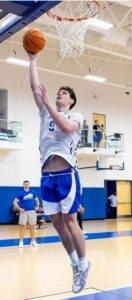 Kentucky Wildcats player Trent Noah wearing white and blue jersey on basketball court